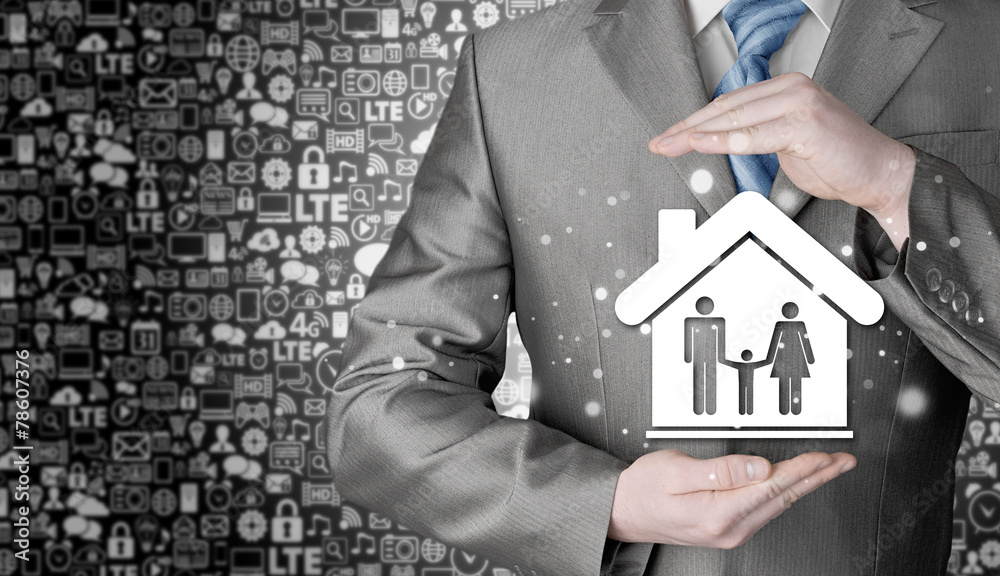 businessman protecting family in home with hands businessman protecting family in home with hands