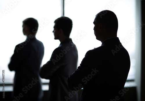 silhouette of three businessmen in the office