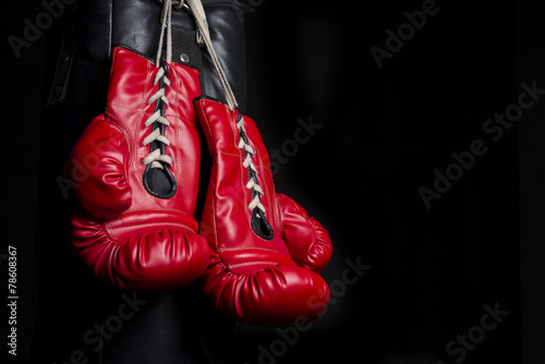 A pair of red boxing gloves with low key lighting © bhakpong