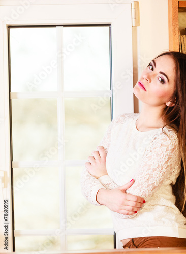 Beautiful woman looking through window.
