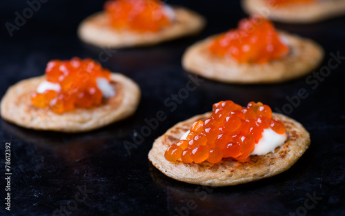 Buckwheat blini with red caviar and sour cream