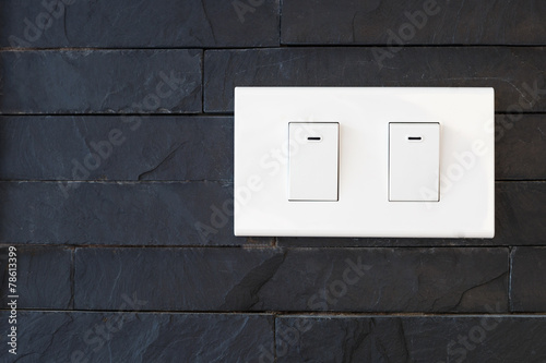 switch light on black stone wall