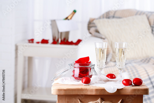 Champagne glasses and rose petals for celebrating Valentines