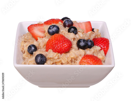 Oatmeal with berries isolated on white