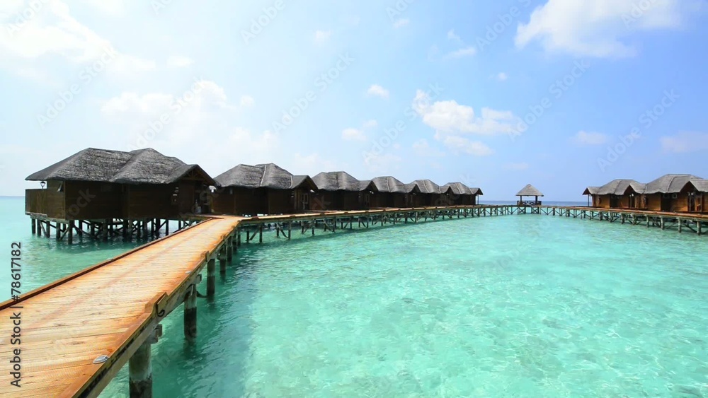Over water bungalows with steps into amazing green lagoon Over water bungalows with steps into amazing green lagoon