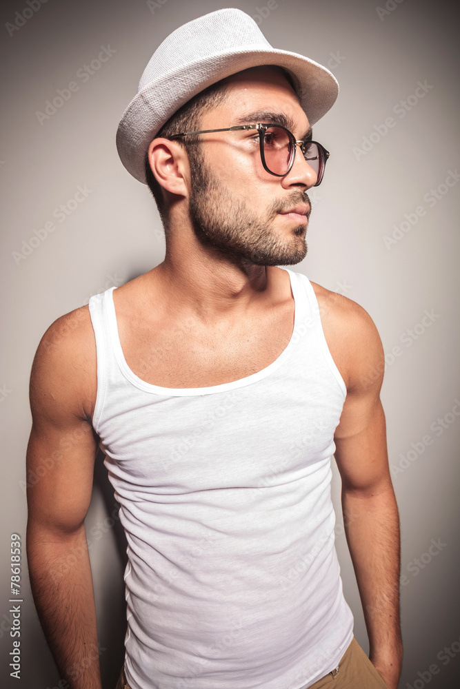young casual man holding his hands in pocket young casual man holding his hands in pocket