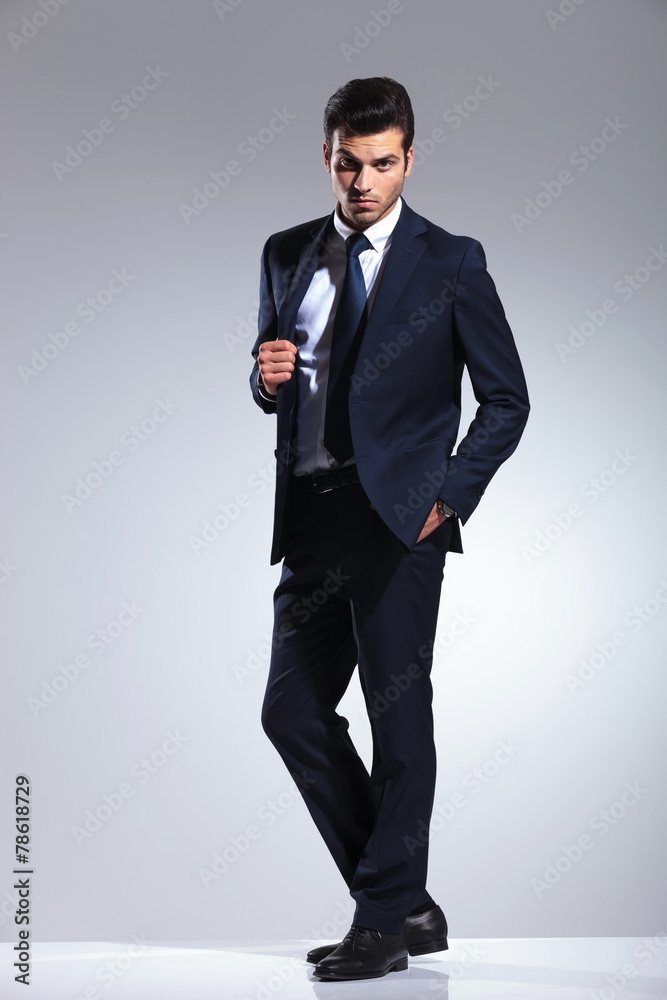 handsome young business man pulling his jacket handsome young business man pulling his jacket