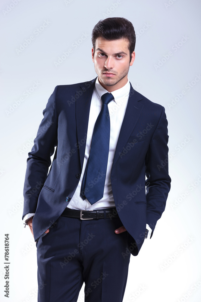 Attractive business man posing on grey studio background Attractive business man posing on grey studio background