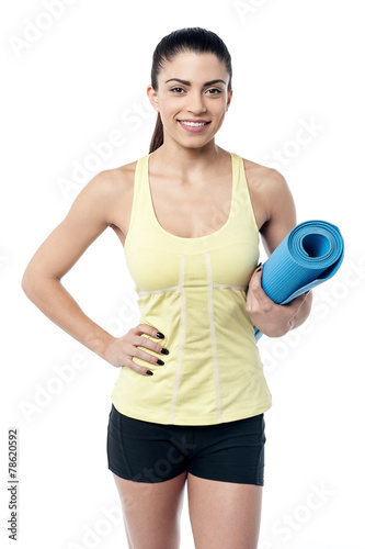 Fit woman with a gym mat