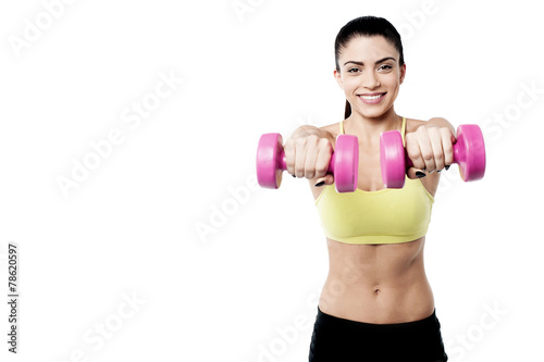 Happy woman lifting dumbbells © stockyimages