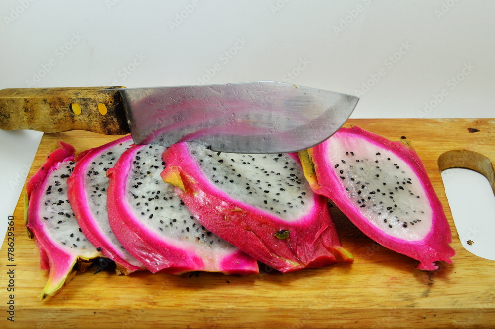 dragon fruit and knife on chopping block