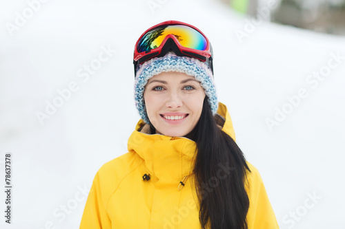 happy young woman in ski goggles outdoors © Syda Productions