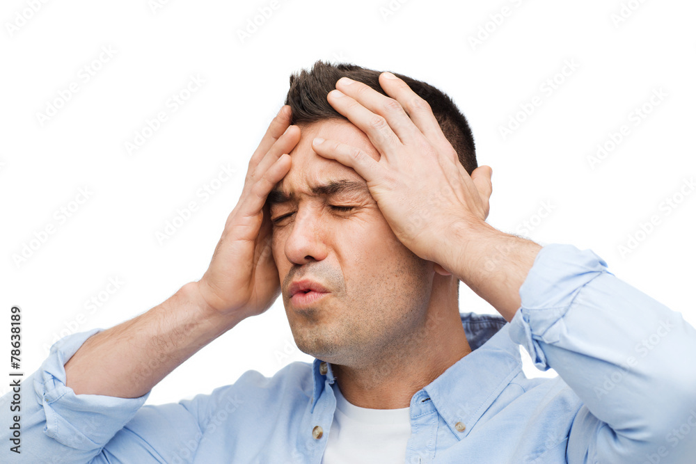 unhappy man with closed eyes touching his forehead unhappy man with closed eyes touching his forehead