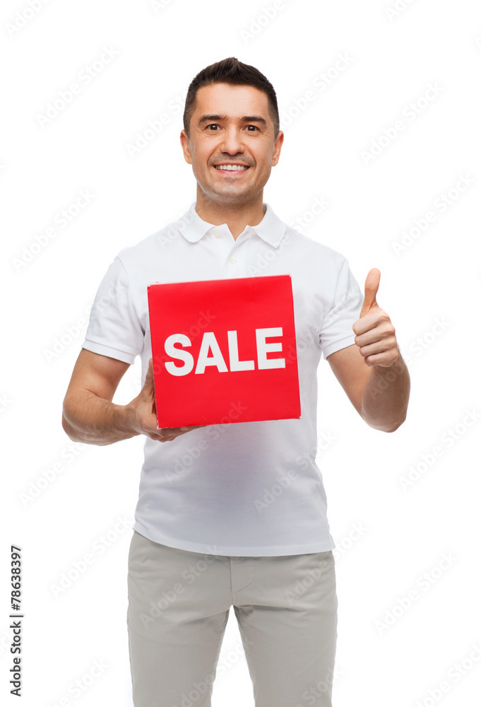 smiling man with red sale sigh showing thumbs up smiling man with red sale sigh showing thumbs up