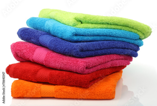 colorful stacked bathroom towels on a white background photo
