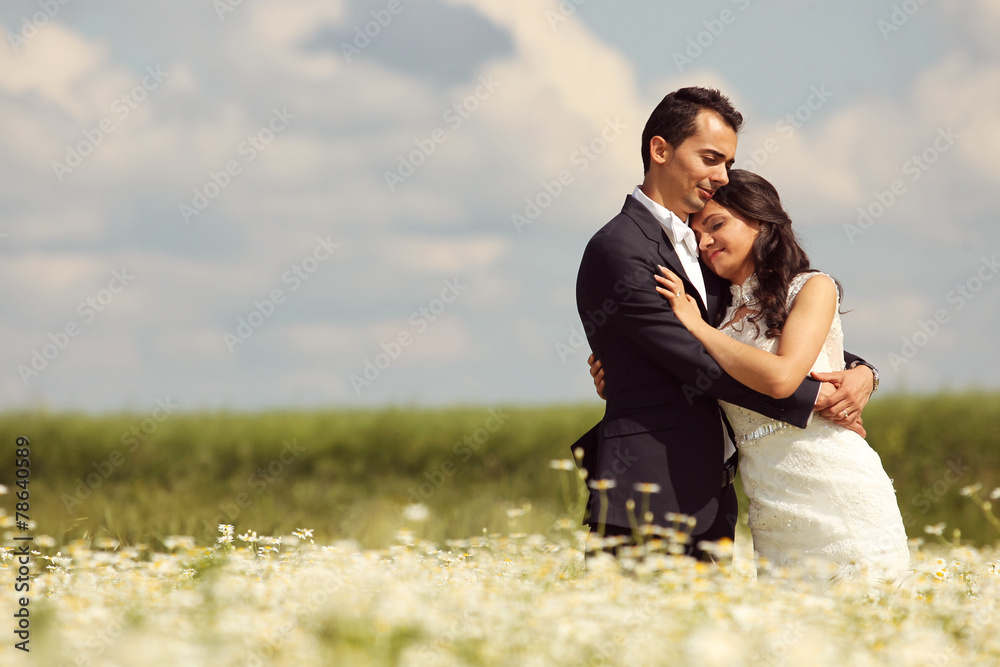 Bride and Groom posing in the fields