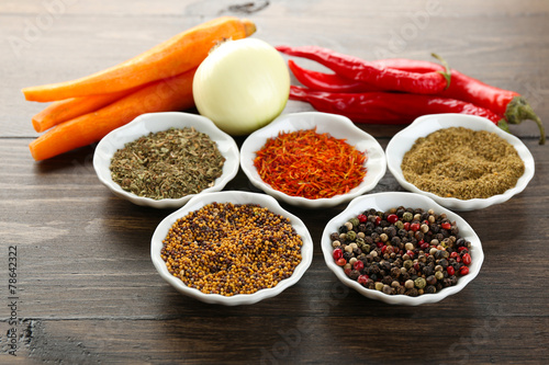 Different kinds of spices in bowls close-up,