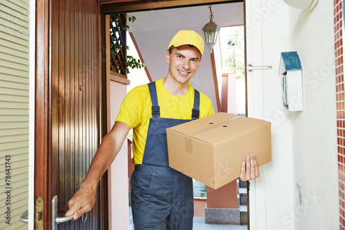 delivery man with parcel box indoors