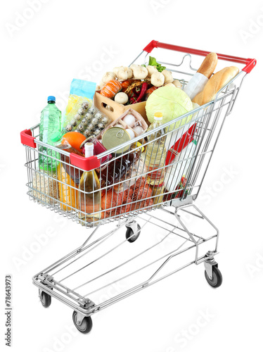 Shopping cart full with various groceries isolated on white