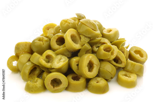 bunch of cut green olive rings on a white background