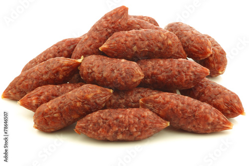 small cervelat sausages on a white background