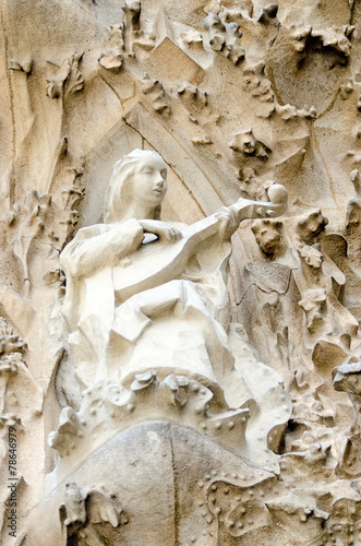 Sculpture of a woman playing on musical instrument