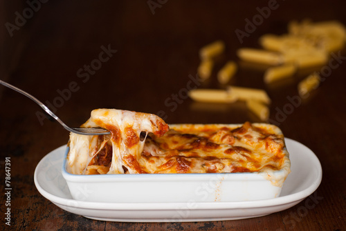 Baked penne pasta with tomato sauce and cheese