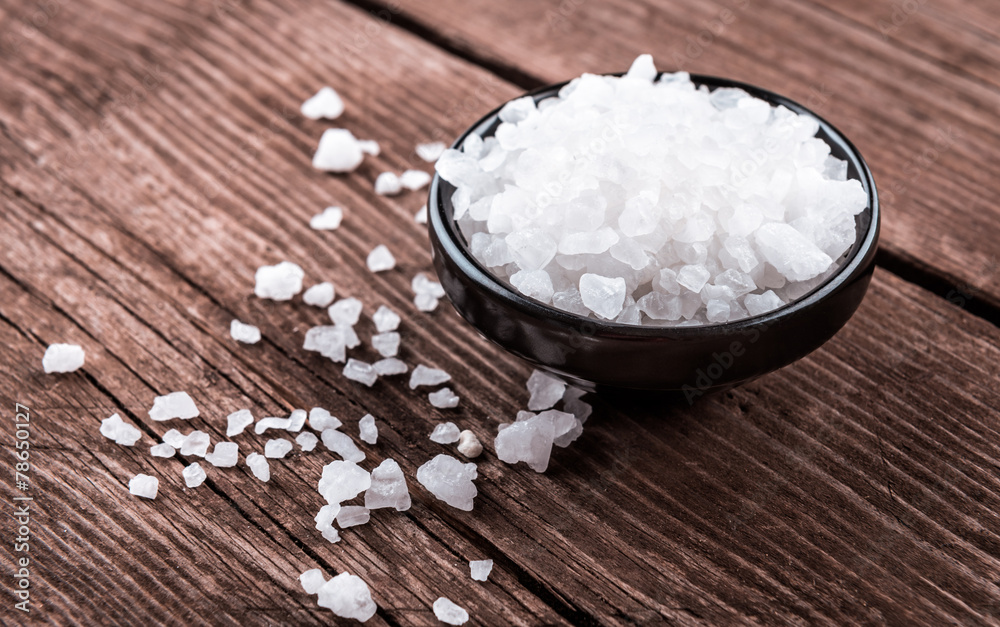 sea salt in bowl on wooden background sea salt in bowl on wooden background