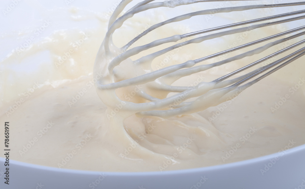 Mixed batter in a bowl and whisk