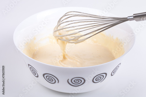 Mixed batter in a bowl and whisk