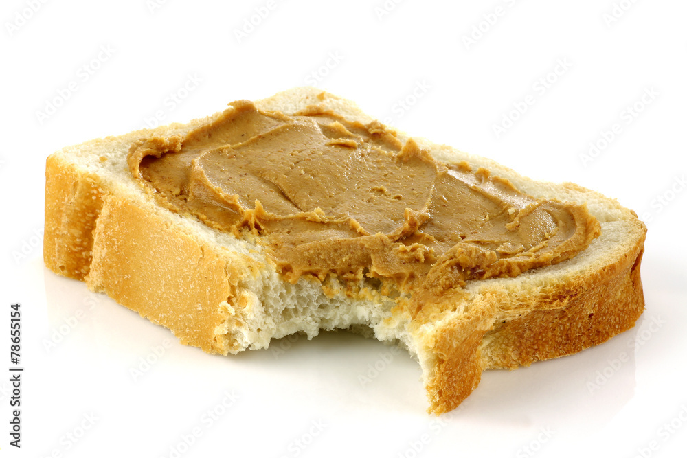 sliced white bread with peanut butter on a white background