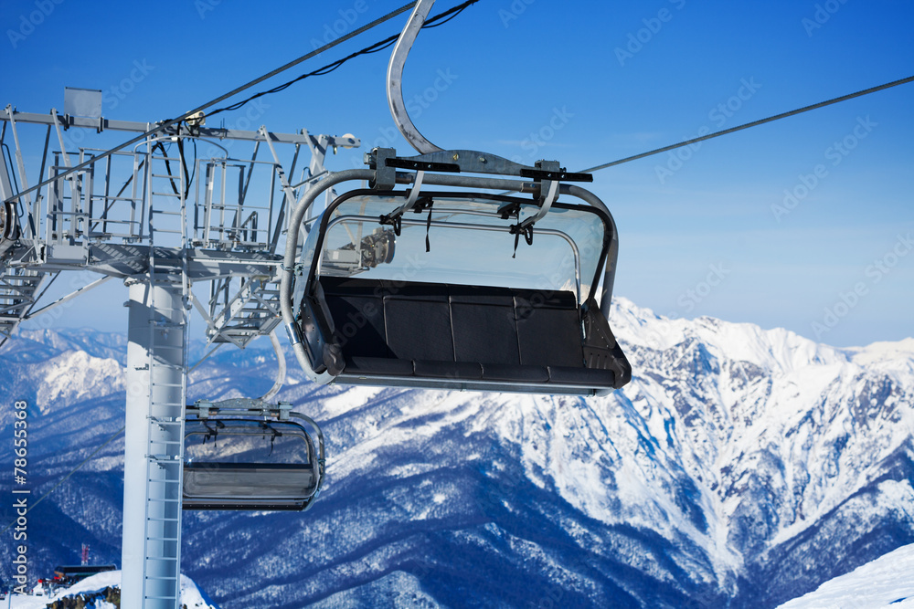 Close view of chairlift and mountains on resort Close view of chairlift and mountains on resort