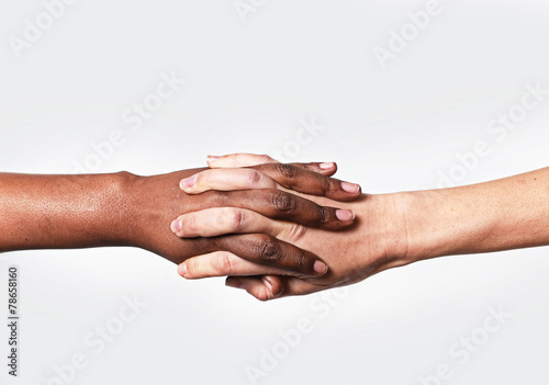 Caucasian hand and black African holding fingers world diversity
