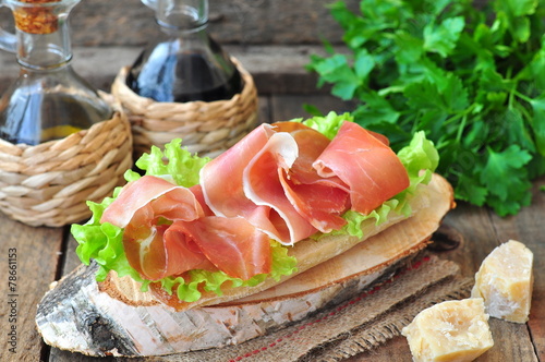 Closeup of delicious parma ham sandwich on wooden backgraund