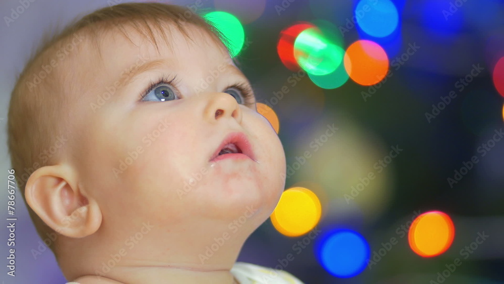 The baby look and smile. Close-up portrait view The baby look and smile. Close-up portrait view