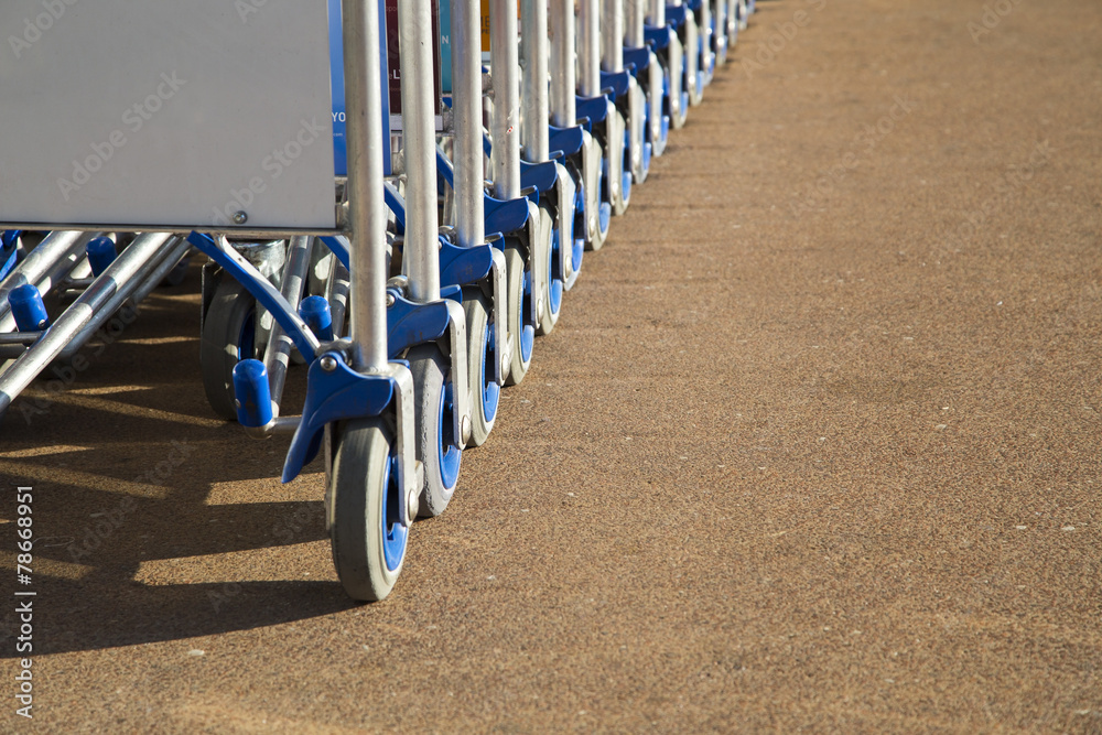 Row of luggage carts with advertisement space closeup view