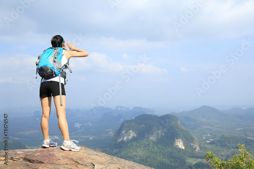 young woman hiker yelling at mountain peak