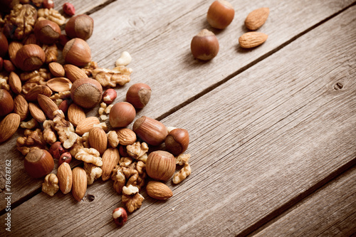 Mixed nuts on old wooden background