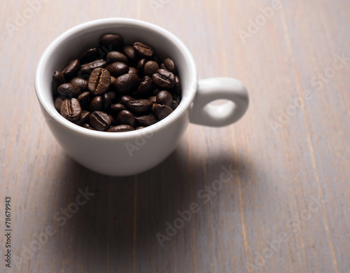 Coffee crop beans in white espresso cup