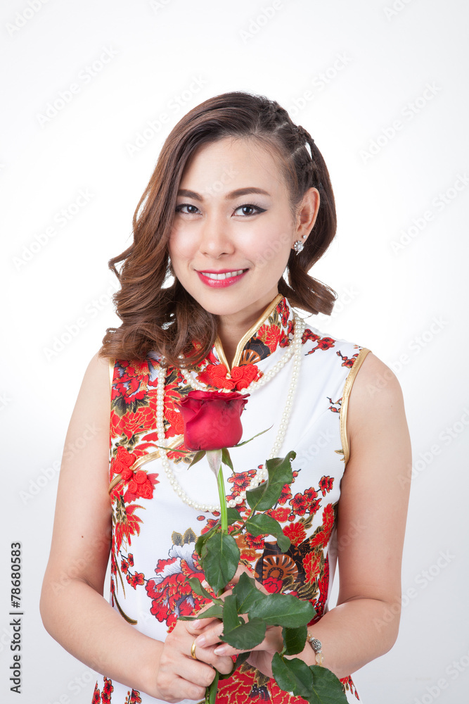Chinese woman in cheongsam with rose. Chinese woman in cheongsam with rose.