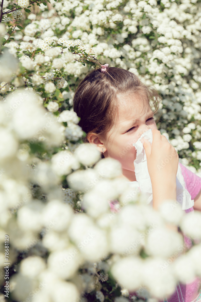 Little girl is blowing her nose, selective focus Little girl is blowing her nose, selective focus