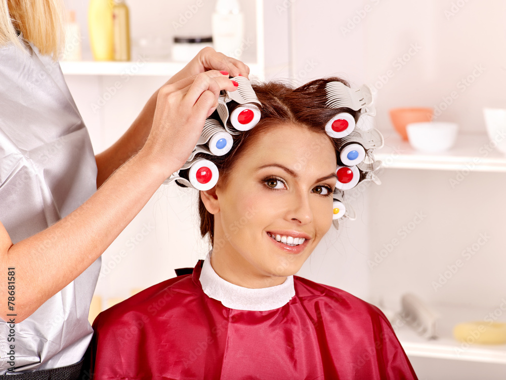 Naklejka premium Woman wear hair curlers on head.