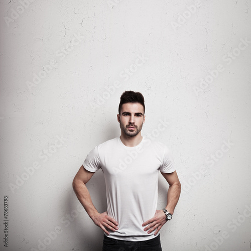 Man in blank t-shirt, wooden wall background