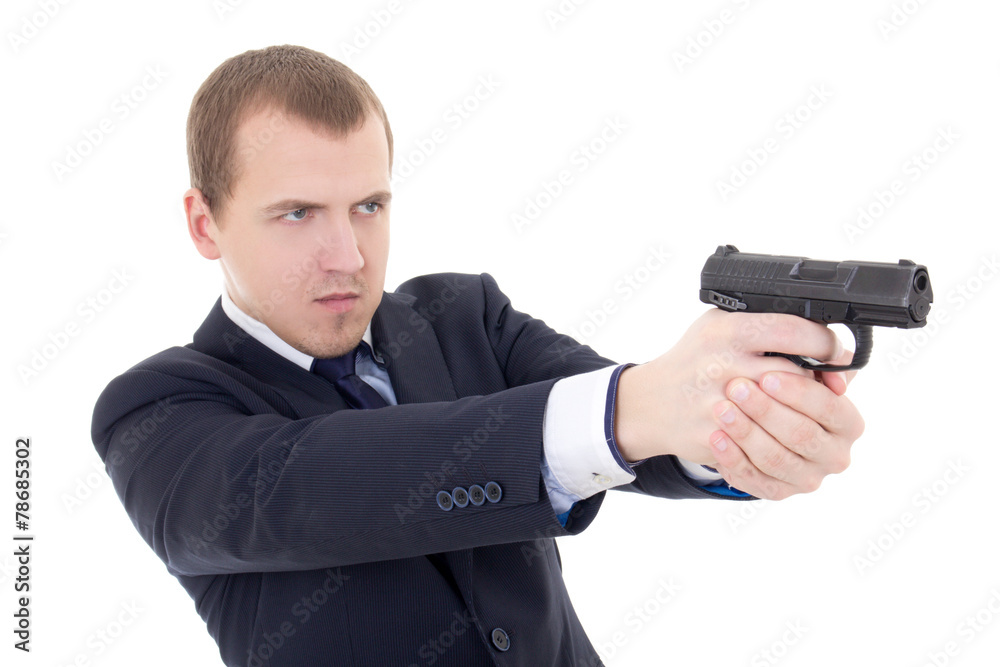 young man in business suit shooting with gun isolated on white young man in business suit shooting with gun isolated on white