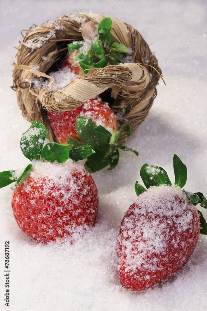Strawberries in a basket on white snow Strawberries in a basket on white snow