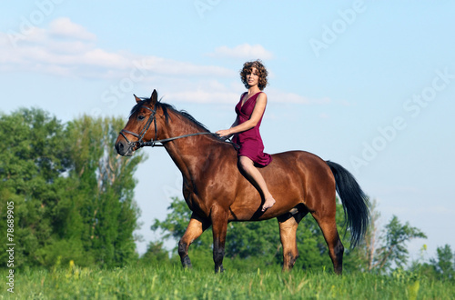 Fashionable portrait of a beautiful young woman and horse