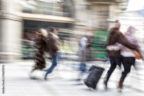 A shopper walking past a store window