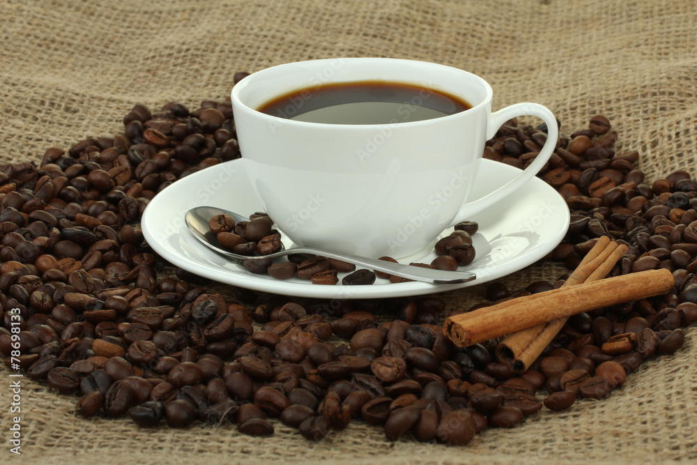 cup with coffee beans on sackcloth cup with coffee beans on sackcloth