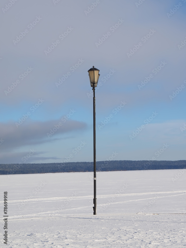 Lantern on the bank of lake in the winter