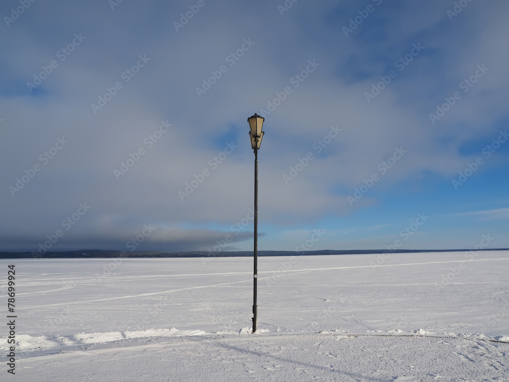 Lantern on the bank of lake in the winter